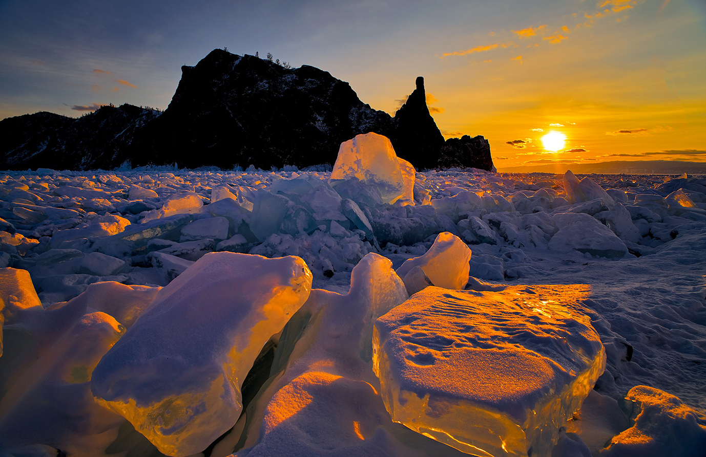 Warm rays of sunlight blanketing the icy terrain of Lake Baikal