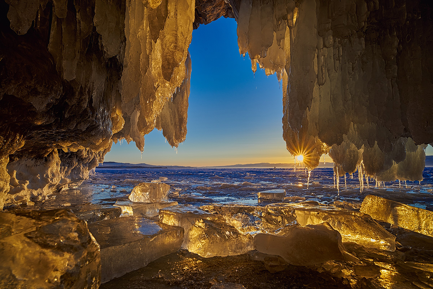 Sunset with starburst shot from inside an ice cave
